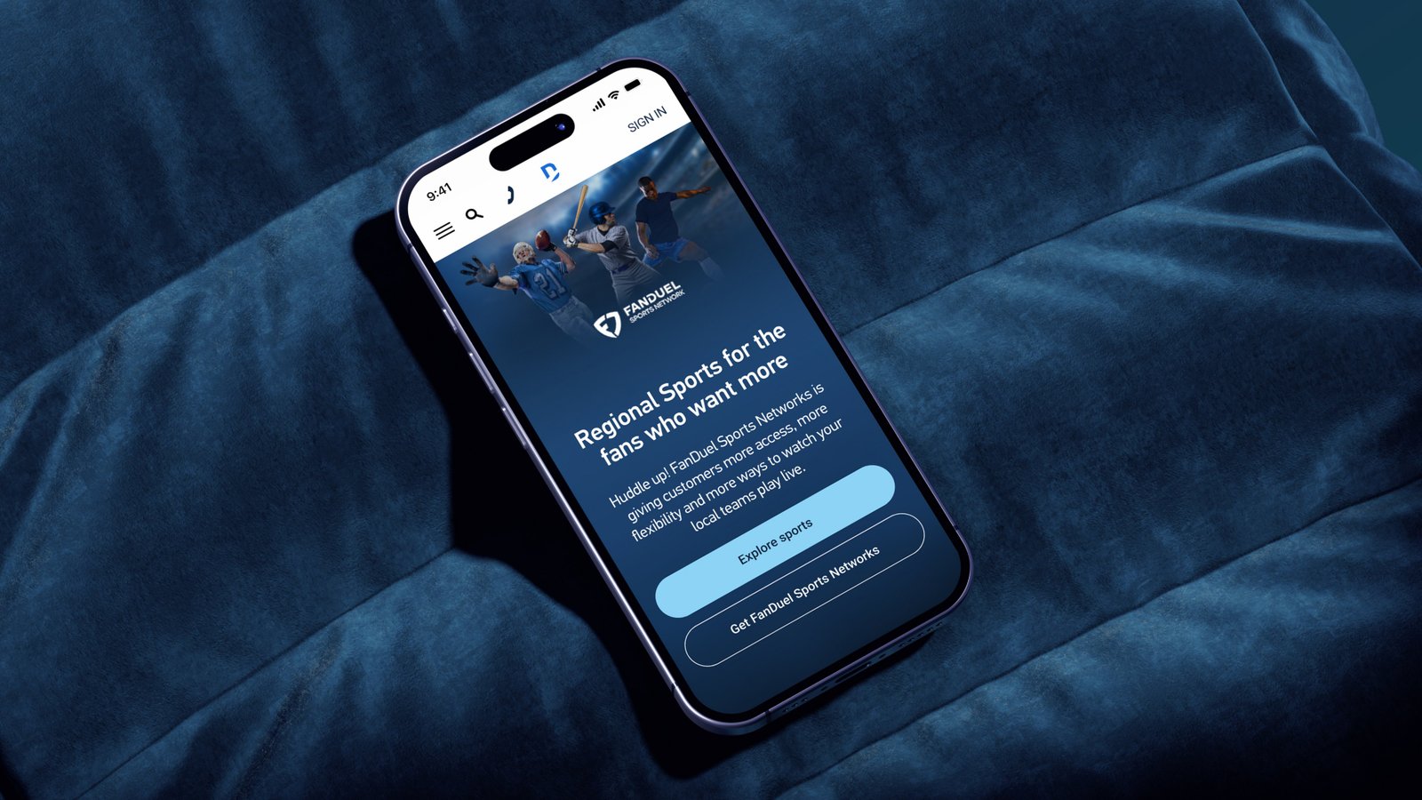 The DIRECTV FanDuel Sports Network page on a phone resting on a velvet sofa