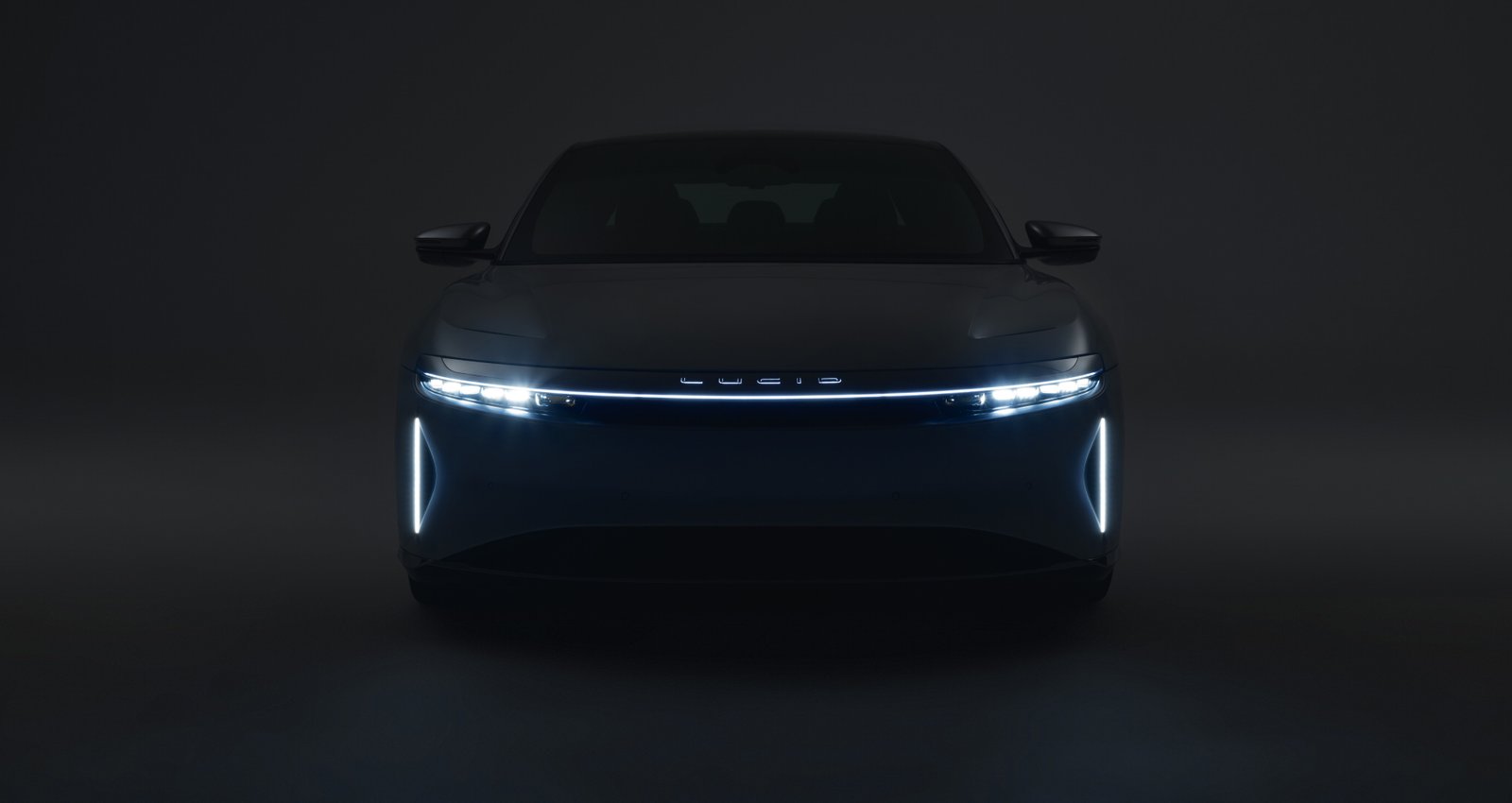 Front view of a Lucid Air in a dark studio